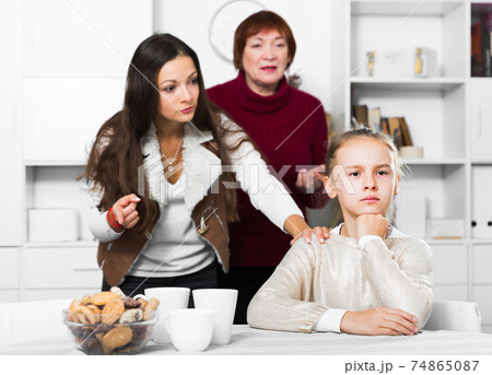 Upset girl scolded by mother and grandma 74865087