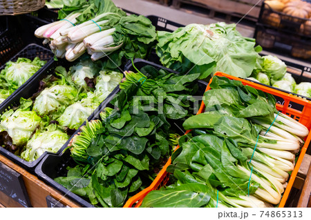 Counter of greengrocery with fresh greens 74865313