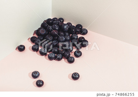 A pile of blueberries is scattered in the corner. Modern still life composition 74866255