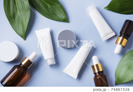 White tubes of cream on a blue background White tubes of cream on a blue background 74867326