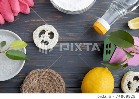 The concept of eco-friendly home cleaning. Various items and ingredients for eco-cleaning the house on a wooden background with space for text. The concept of eco-friendly home cleaning. Various items and ingredients for eco-cleaning the house on a wooden background with space for text. 74869929