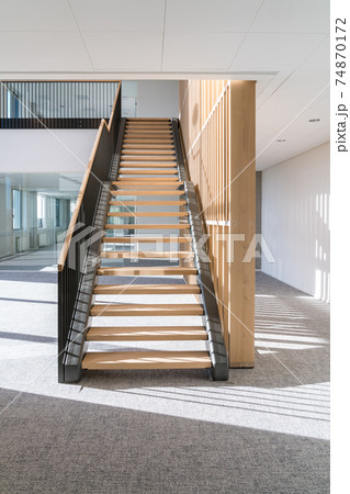 This beautiful wooden staircase is located in the middle of a large building 74870172