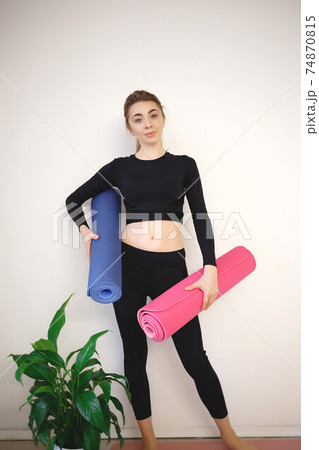 girl holding a pink and blue sports mat girl holding a pink and blue sports mat 74870815