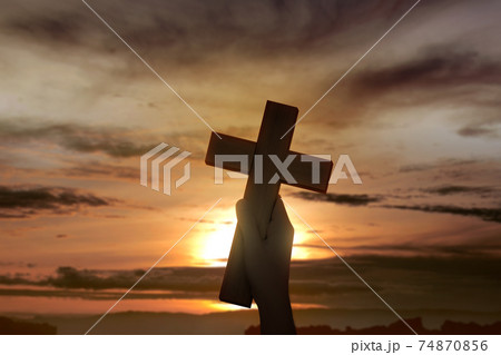 Human hand holding Christian cross 74870856