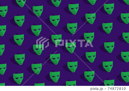 Green Carnival mask on purple background. Green Carnival mask on purple background. 74872810