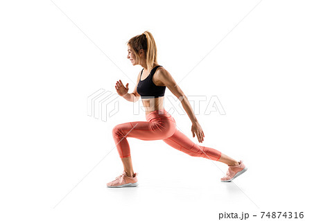 Young caucasian female model in action, motion isolated on white background. Concept of sport, movement, energy and dynamic, healthy lifestyle. Training, practicing. Young caucasian female model in action, motion isolated on white background. Concept of sport, movement, energy and dynamic, healthy lifestyle. Training, practicing. 74874316