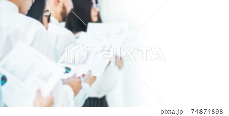 blurred image for the advertising text. photo with copy space. business team with financial documents standing in the office. 74874898