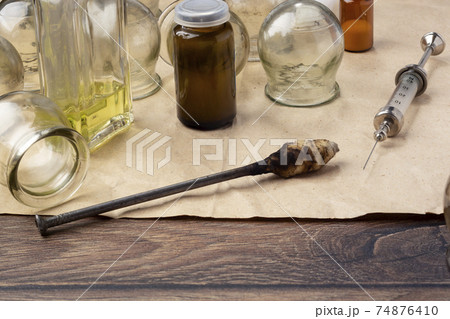 Retro medical jars for vacuum therapy and vintage reusable syringe 74876410