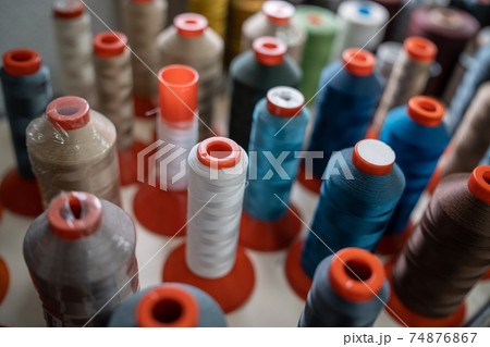 closeup of color sewing thread set at textile or clothing factory or manufacture closeup of color sewing thread set at textile or clothing factory or manufacture 74876867