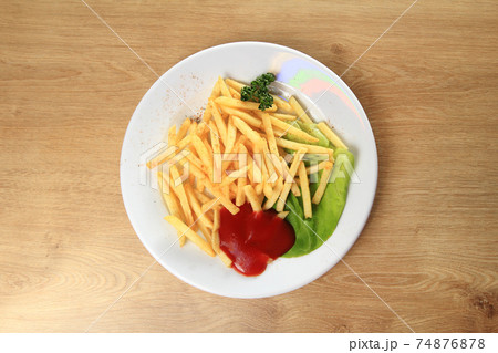fried potatoes and sauce on a white plate fried potatoes and sauce on a white plate 74876878