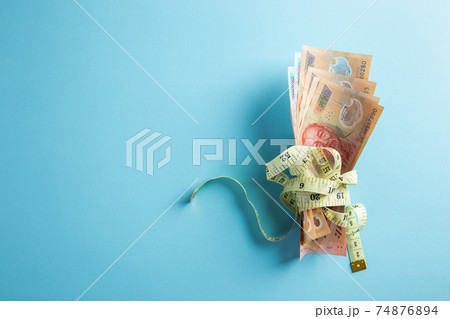 Money with a tape measure. Price growth. Inflation Concept. 74876894