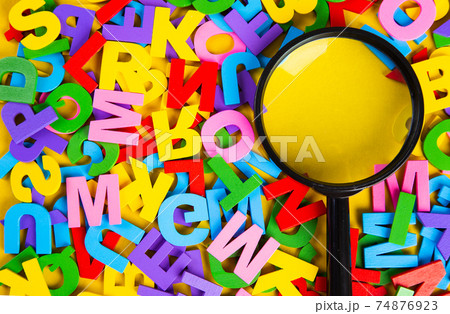 Magnifying glass with colorful alphabet on yellow background, Copy space.Education concept. 74876923
