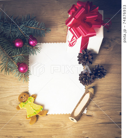 Christmas card: blank, vintage rural gift and Christmas tree branch on wooden background with gift Christmas card: blank, vintage rural gift and Christmas tree branch on wooden background with gift 74876933