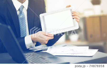 Businessman hands are holding the touch screen device. 74876958