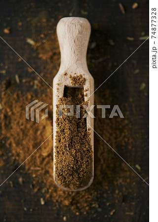 garam masala in a wooden scoop garam masala in a wooden scoop 74877328
