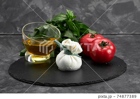 Cheese collection, fresh soft white burrata cheese ball made from mozzarella and cream from Apulia, Italy, close up Cheese collection, fresh soft white burrata cheese ball made from mozzarella and cream from Apulia, Italy, close up 74877389