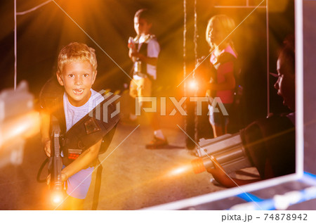 Portrait of lucky tweenager boy with laser gun Portrait of lucky tweenager boy with laser gun 74878942