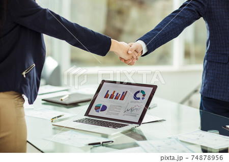 shaking hands with financial partners near the workplace shaking hands with financial partners near the workplace 74878956