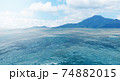 Summer view of the sea and mountain range. Island of rocks in the ocean, mountain island on the horizon, panorama of ocean landscape with island, 3D rendering 74882015