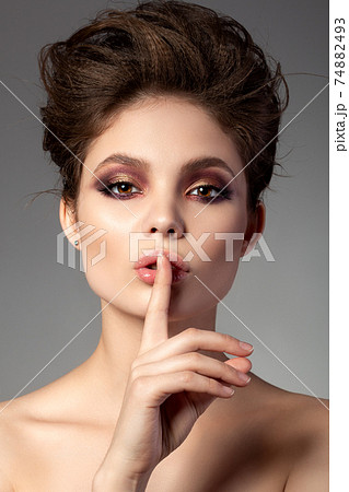 Portrait of beautiful woman with evening makeup Portrait of beautiful woman with evening makeup 74882493