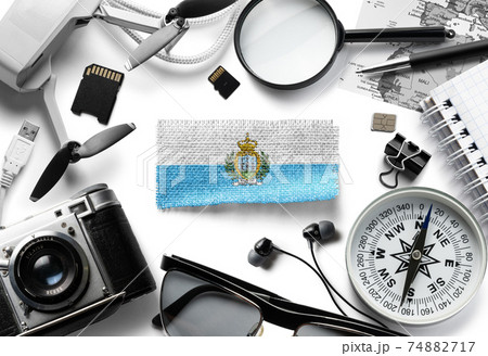 Flag of San Marino and travel accessories on a white background. 74882717