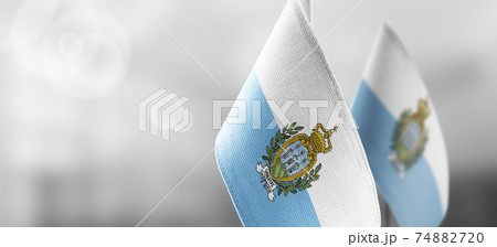 Small national flags of the San Marino on a light blurry background Small national flags of the San Marino on a light blurry background 74882720