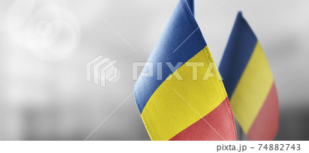 Small national flags of the Romania on a light blurry background Small national flags of the Romania on a light blurry background 74882743