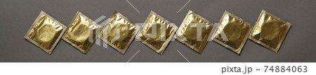 Blank condoms on gray background, top view Blank condoms on gray background, top view 74884063