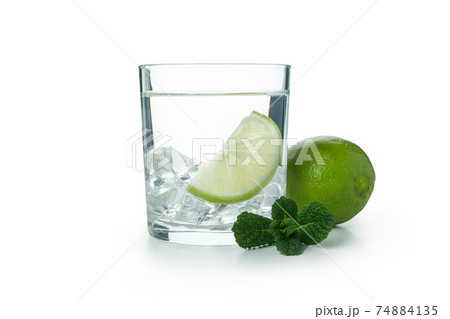 Glass of vodka with lime and ice isolated on white background 74884135