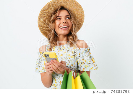 Happy young woman wearing light dress and straw hat Happy young woman wearing light dress and straw hat 74885798