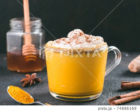 golden turmeric latte and ingredients, copy space 74886169
