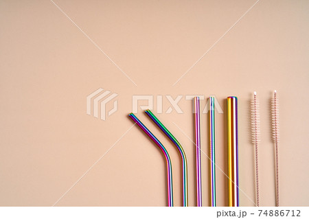 The modern trend in environmental care. Reusable metal straws for drinks. Replacement with common plastic beverage straws 74886712