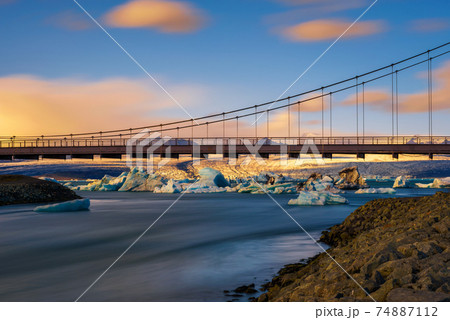 Road bridge over Jokulsarlon glacier lagoon in Iceland at sunset Road bridge over Jokulsarlon glacier lagoon in Iceland at sunset 74887112