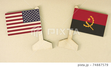 Flags of the USA and Angola made of recycled paper on the cardboard desk, flat layout Flags of the USA and Angola made of recycled paper on the cardboard desk, flat layout 74887579