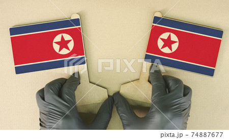 Flags of North Korea made of recycled paper on the cardboard table 74887677