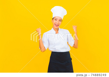 Portrait beautiful young asian woman in chef or cook uniform with hat Portrait beautiful young asian woman in chef or cook uniform with hat 74889249