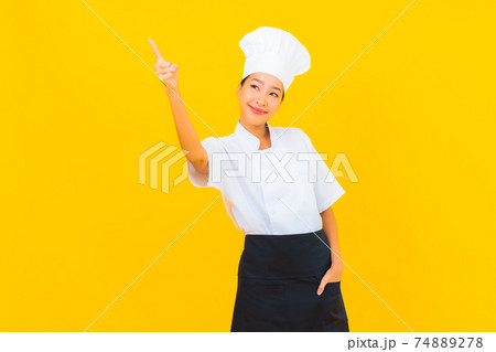 Portrait beautiful young asian woman in chef or cook uniform with hat Portrait beautiful young asian woman in chef or cook uniform with hat 74889278