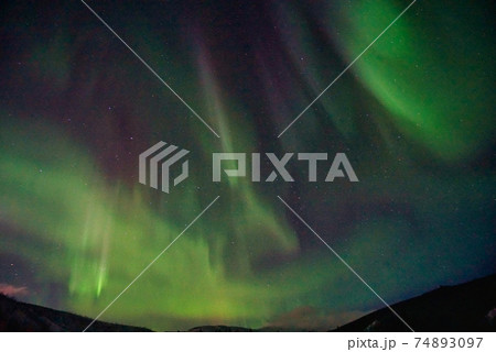 Aurora borealis in the night sky. The light colors are green, yellow, and red. Photographed in Alaska, the USA on March 17, 2016 Aurora borealis in the night sky. The light colors are green, yellow, and red. Photographed in Alaska, the USA on March 17, 2016 74893097