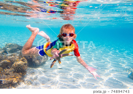 Child snorkeling. Kids underwater. Beach and sea. 74894743