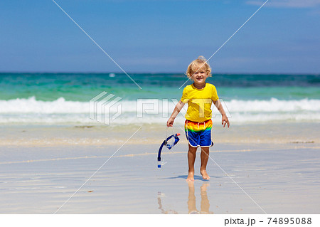 Child snorkeling on tropical beach. Kids snorkel. 74895088