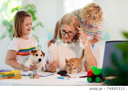 Mother working from home with kids. Quarantine. Mother working from home with kids. Quarantine. 74895313