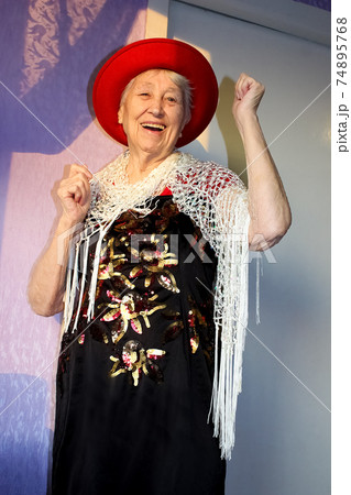 Happy smiling funny senior woman wearing beads dancing 74895768