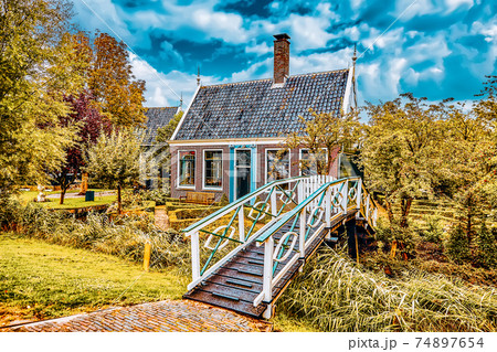 Typical, authentic village with cozy houses of the countryside in the Netherlands. Typical, authentic village with cozy houses of the countryside in the Netherlands. 74897654