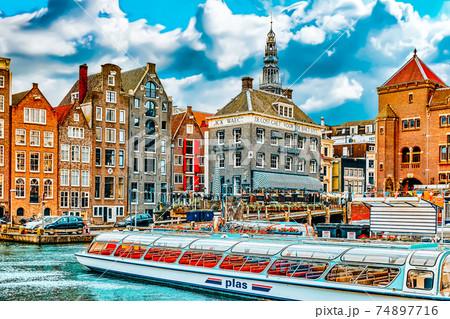 AMSTERDAM, NETHERLANDS - SEPTEMBER 15, 2015: Beautiful views of the streets, ancient buildings, people, embankments of Amsterdam - also call "Venice in the North". Netherlands 74897716