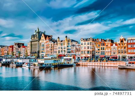 AMSTERDAM, NETHERLANDS - SEPTEMBER 15, 2015: Beautiful views of the streets, ancient buildings, people, embankments of Amsterdam - also call "Venice in the North". Netherlands 74897731