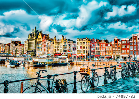 AMSTERDAM, NETHERLANDS - SEPTEMBER 15, 2015: Beautiful views of the streets, ancient buildings, people, embankments of Amsterdam - also call "Venice in the North". Netherlands 74897732