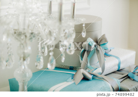 Boxes with gifts Packed in blue and silver paper are on the shelf Boxes with gifts Packed in blue and silver paper are on the shelf 74899482