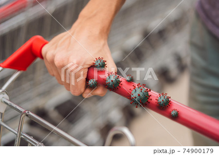 Coronaviruses Covid-19 on a trolley handle in a supermarket, during the pandemic of Coronavirus 74900179