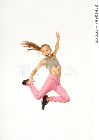 Cute sporty girl jumping and screaming with joy Cute sporty girl jumping and screaming with joy 74901453