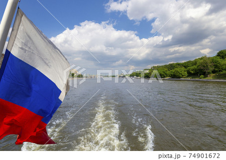Russia flag and Moskva River and embankments (view from tourist pleasure boat). Moscow, Russia Russia flag and Moskva River and embankments (view from tourist pleasure boat). Moscow, Russia 74901672
